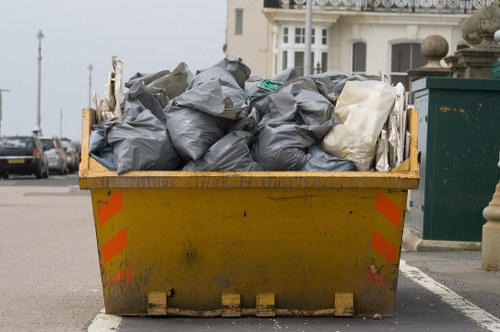 Waste collection crew handling rubbish in London street